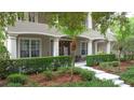Inviting home featuring beautiful front yard landscaping and a grand entrance with large windows at 3372 Bellington Dr, Orlando, FL 32835