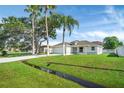 Lovely home with a manicured lawn, and a charming small creek adds to the appeal of the property at 340 Edgewood Ct, Kissimmee, FL 34759