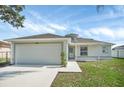 Charming one-story home featuring a two-car garage, sidewalk and a well-maintained lawn at 340 Edgewood Ct, Kissimmee, FL 34759