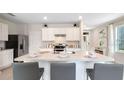Open concept kitchen with large island and breakfast bar seating at 3519 Mcway Falls Ct, Davenport, FL 33837