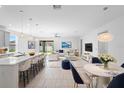 Bright, open-concept living spaces, including modern kitchen, dining area, and living room at 417 Tisone Ln, Davenport, FL 33837