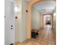 Beautiful hallway with neutral walls, stylish archways, and tiled flooring at 500 Mirasol Cir # 203, Celebration, FL 34747