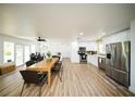 Open-concept living space with modern kitchen, dining area, and comfortable workspace, perfect for versatile living at 5365 Rambling Rd, St Cloud, FL 34771