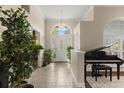 Bright foyer with tiled floors, high ceilings, and a decorative front door, creating a welcoming entrance at 6234 Tremayne Dr, Mount Dora, FL 32757