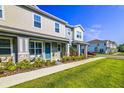 Attractive townhomes featuring covered entryways and beautifully landscaped lawns and shrubbery at 625 Dogfish Ln, Debary, FL 32713