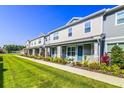 Attractive townhomes featuring covered entryways and beautifully landscaped lawns and shrubbery at 625 Dogfish Ln, Debary, FL 32713