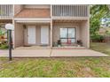 Two-story townhouse exterior with neutral siding, a walkway, and an area for plants at 752 Howland Ln # 114, Altamonte Springs, FL 32701