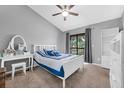 Lovely bedroom with a ceiling fan, neutral paint, a writing desk, and balcony access at 752 Howland Ln # 114, Altamonte Springs, FL 32701