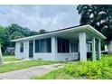 Charming home showcasing a screened porch with a covered carport on the side at 820 Maley St, Daytona Beach, FL 32114