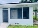 Enclosed screened porch offering a view of the house's interior door and adjacent carport at 820 Maley St, Daytona Beach, FL 32114