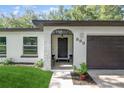 Inviting front entrance showcases decorative door with sidelights, arched transom window and meticulously maintained landscaping at 898 Shed St, Oviedo, FL 32765