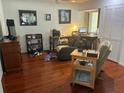 Office area with dark wood floors, a ceiling fan, and bright natural light at 116 Oakmont Ln, New Smyrna Beach, FL 32168