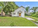 Charming home with an orange front door, neutral siding, and a covered carport at 1161 Dot Dr, Altamonte Springs, FL 32714