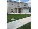 Inviting home with a charming front porch featuring a hanging chair and tidy landscaping at 1193 Catskill Dr, Haines City, FL 33844