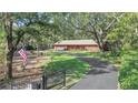 Beautiful single-story home with mature trees, long driveway and well manicured lawn at 127 Oak Ln, Ormond Beach, FL 32174