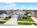 Spacious two-story home with a three-car garage, lush lawn, and beautiful landscaping in a residential neighborhood at 13194 Magnolia Valley Dr, Clermont, FL 34711