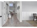 Inviting entryway features shiplap walls, light wood floors, and a view of the living room at 13194 Magnolia Valley Dr, Clermont, FL 34711