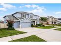 Charming two-story home with a three-car garage, well-maintained lawn, and manicured landscaping at 13194 Magnolia Valley Dr, Clermont, FL 34711