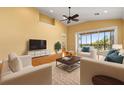 Bright living room with high ceilings, hardwood floors, and large windows at 14 Camino Real Blvd # 14, Howey In The Hills, FL 34737