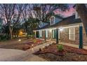 Beautiful home featuring a brick facade, dormer windows, covered porch, and professional landscaping at 140 Sweet Bay Cir, Lake Mary, FL 32746