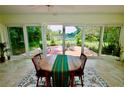 Bright sunroom dining area with views of the outdoor patio and lush backyard at 1405 Periwinkle Ave, Deland, FL 32724