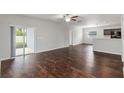 Spacious living room featuring hardwood floors and sliding glass doors to the backyard at 141 Sandestin Dr, Haines City, FL 33844