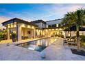 Lush backyard with a modern pool, sun loungers, and an outdoor dining area perfect for entertaining at 14106 Eliot Ave, Orlando, FL 32827