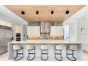 Contemporary kitchen featuring a large island with seating, custom cabinetry, and modern appliances at 14106 Eliot Ave, Orlando, FL 32827