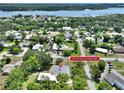 Beautiful aerial view of a charming home near the river with lush green trees and neighborhood at 1510 Live Oak St, New Smyrna Beach, FL 32168