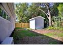 The backyard features lush grass, a shed, and a privacy fence at 1510 Live Oak St, New Smyrna Beach, FL 32168