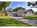 Beautiful exterior view of a three-car garage and driveway in the front yard at 1510 Live Oak St, New Smyrna Beach, FL 32168