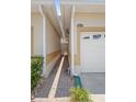 Home exterior featuring a garage and side walkway at 17404 Chateau Pine Way, Clermont, FL 34711