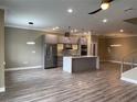 Open-concept kitchen featuring stainless steel appliances and a center island at 2041 Greenbriar Ter, Davenport, FL 33837