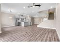 Bright living room featuring wood floors, recessed lighting, and an open layout with modern stairs at 2041 Greenbriar Ter, Davenport, FL 33837