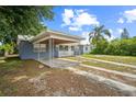 Cozy one-story home featuring a covered carport and a neatly maintained front yard landscape at 2307 Freemason St, Lakeland, FL 33801