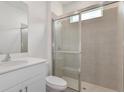 Modern bathroom with glass-enclosed shower, vanity and tile floors at 2524 Raghav Trl, Tavares, FL 32778