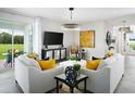 Bright living room featuring modern decor, tile flooring, a large TV, and a sliding glass door leading to an outdoor patio at 2524 Raghav Trl, Tavares, FL 32778