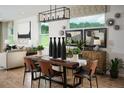 Elegant dining area featuring modern lighting, stylish decor, and views of the outdoor scenery at 2530 Raghav Trl, Tavares, FL 32778
