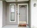 Inviting front door with decorative window and modern hardware, enhancing curb appeal at 359 Westwind Ct, Lake Mary, FL 32746