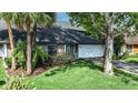 Beautiful home with mature landscaping, an attached two-car garage, and a neatly manicured lawn at 359 Westwind Ct, Lake Mary, FL 32746