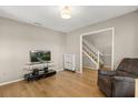 Cozy living space with a TV and entertainment center, next to a stairway, perfect for relaxing and entertainment at 359 Westwind Ct, Lake Mary, FL 32746
