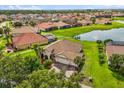 Aerial view of a lakeside home with a private pool and well-manicured lawn at 3847 Shoreside Dr, Kissimmee, FL 34746
