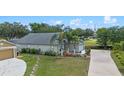 Aerial view of a well-maintained home featuring manicured lawns and mature trees at 404 Obo Dr, Davenport, FL 33896