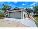 Spacious two-car garage with solar panels, an extra-long driveway and side yard access at 404 Obo Dr, Davenport, FL 33896