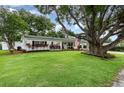 Charming single-story home featuring a lush green lawn and mature tree offering shade and curb appeal at 4111 Dublin St, Orlando, FL 32812