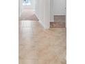 Hallway with tile flooring transitions into carpeted bedrooms in a well-lit home at 437 Caribbean Ct, Kissimmee, FL 34759