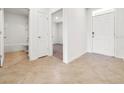 Hallway with tile flooring leading to a bathroom and a bedroom with carpet at 437 Caribbean Ct, Kissimmee, FL 34759
