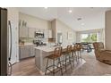 Open kitchen features quartz countertops, stainless steel appliances, and decorative backsplash at 4444 Quartz Ct, Lakeland, FL 33811