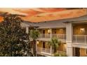 Exterior view of a condo building at sunset with palm trees at 515 Rum Run # 33515, Davenport, FL 33897