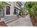 Townhouse exterior features a modern design with brick accents, a welcoming front entrance, and lush landscaping at 52 W Harding St # A, Orlando, FL 32806